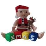 Crochet Christmas baby holding a reindeer with playing blocks