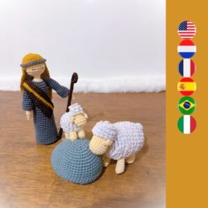 crochet shepherd with 2 sheep and a rock